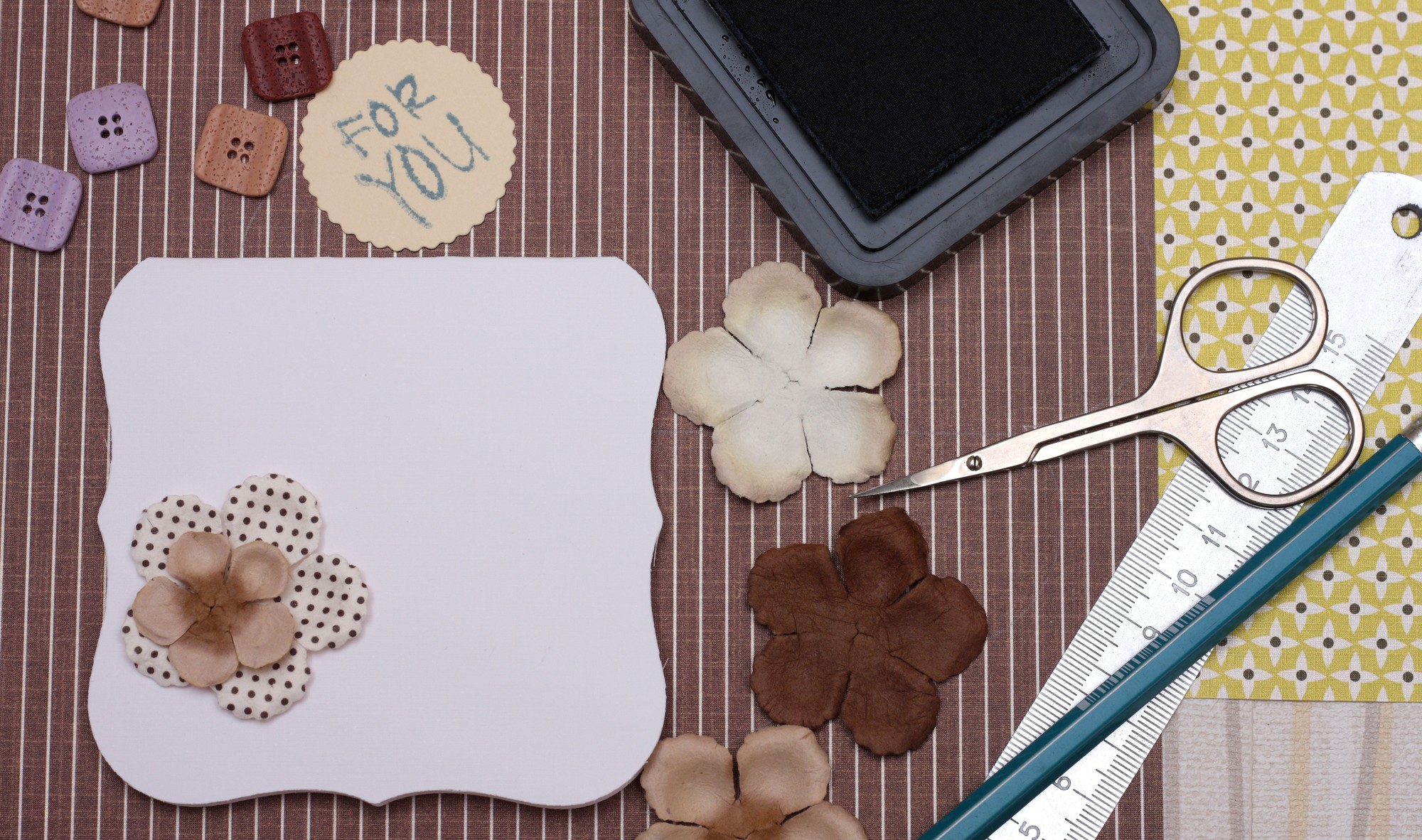 Flatlay of embroidered samples and price list